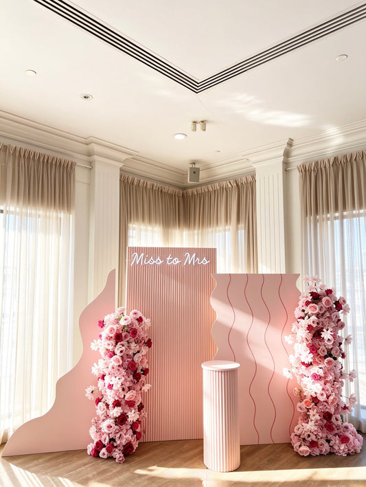 miss to mrs bridal shower backdrop with luxury pink floral arrangements