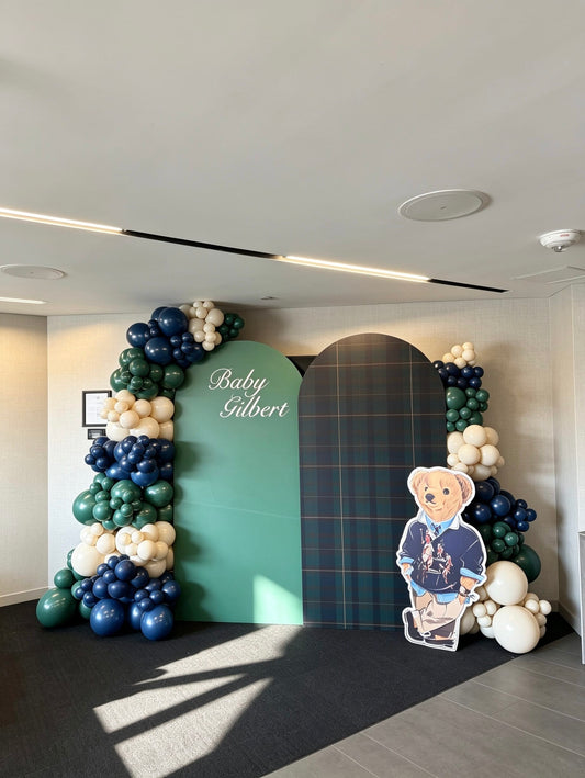 luxury polo inspired baby shower backdrop with tartan panels and navy green balloon garlands