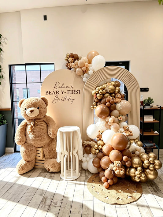 neutral teddy bear first birthday backdrop with ripple arch and balloon garland
