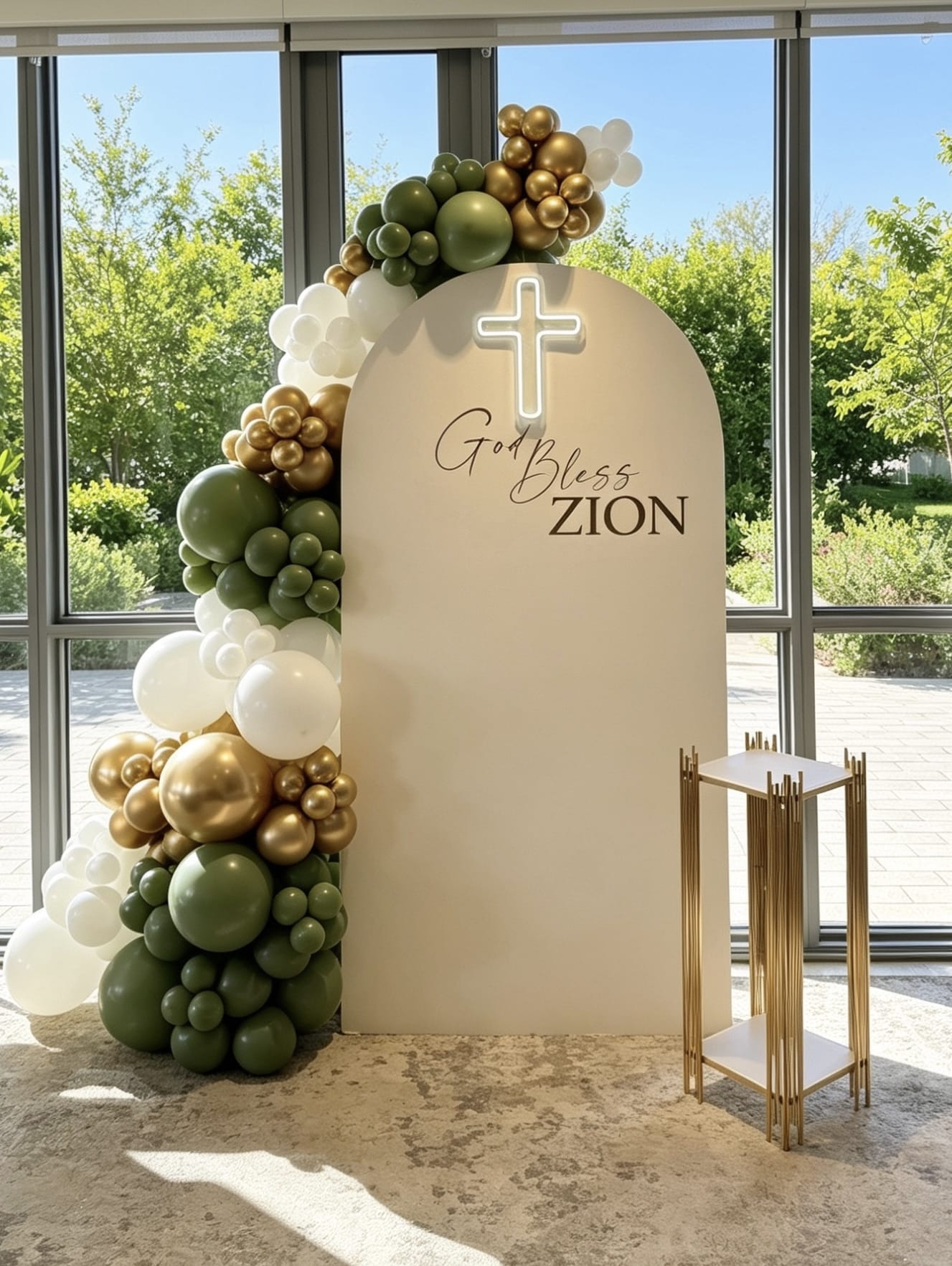 Ivory communion backdrop with illuminated cross and sage green, white and gold balloon garland.
