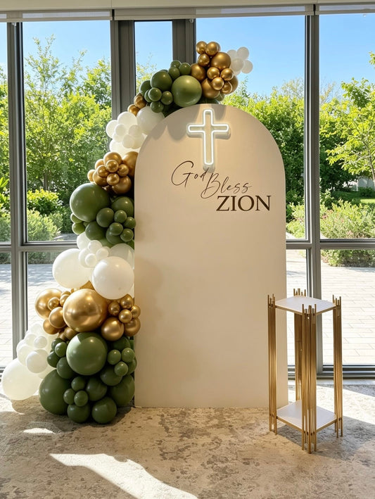 Ivory communion backdrop with illuminated cross and sage green, white and gold balloon garland.