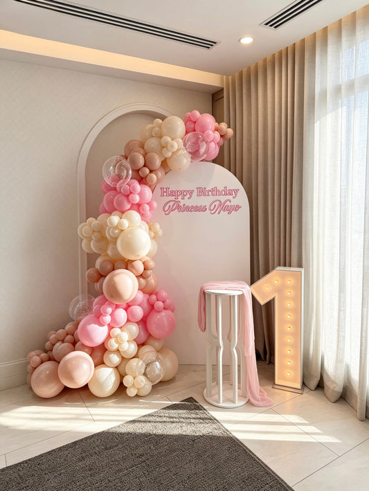 pink princess first birthday backdrop with organic balloon garland and marquee number one