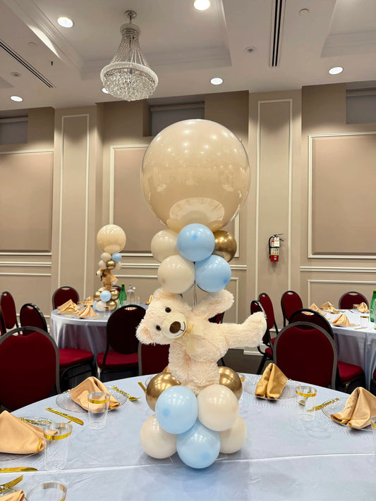 teddy bear balloon centrepiece with jumbo glass-effect balloon and blue white gold balloon arrangement for baby shower table decor
