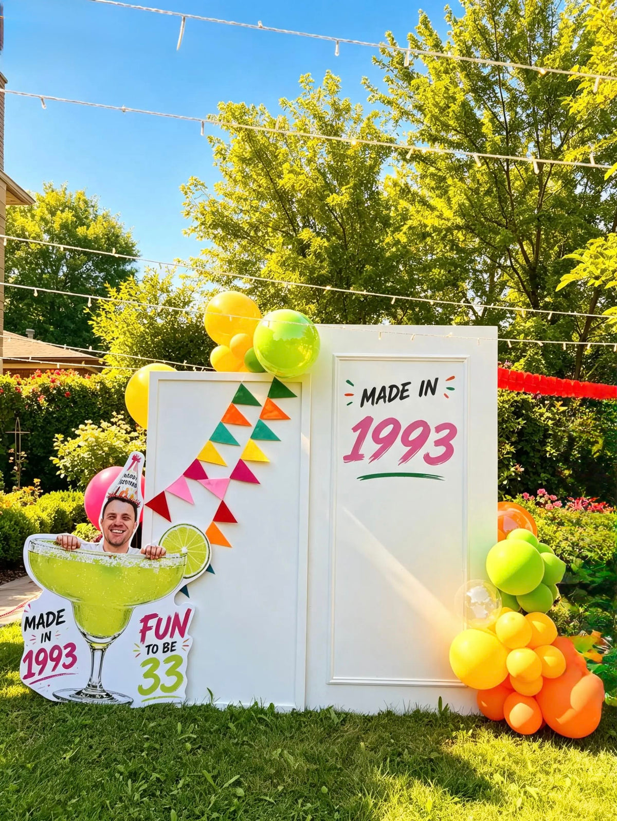 Margarita birthday setup with white backdrops, “Made in 1993” lettering, bright balloons, colourful bunting, and a custom photo cutout.