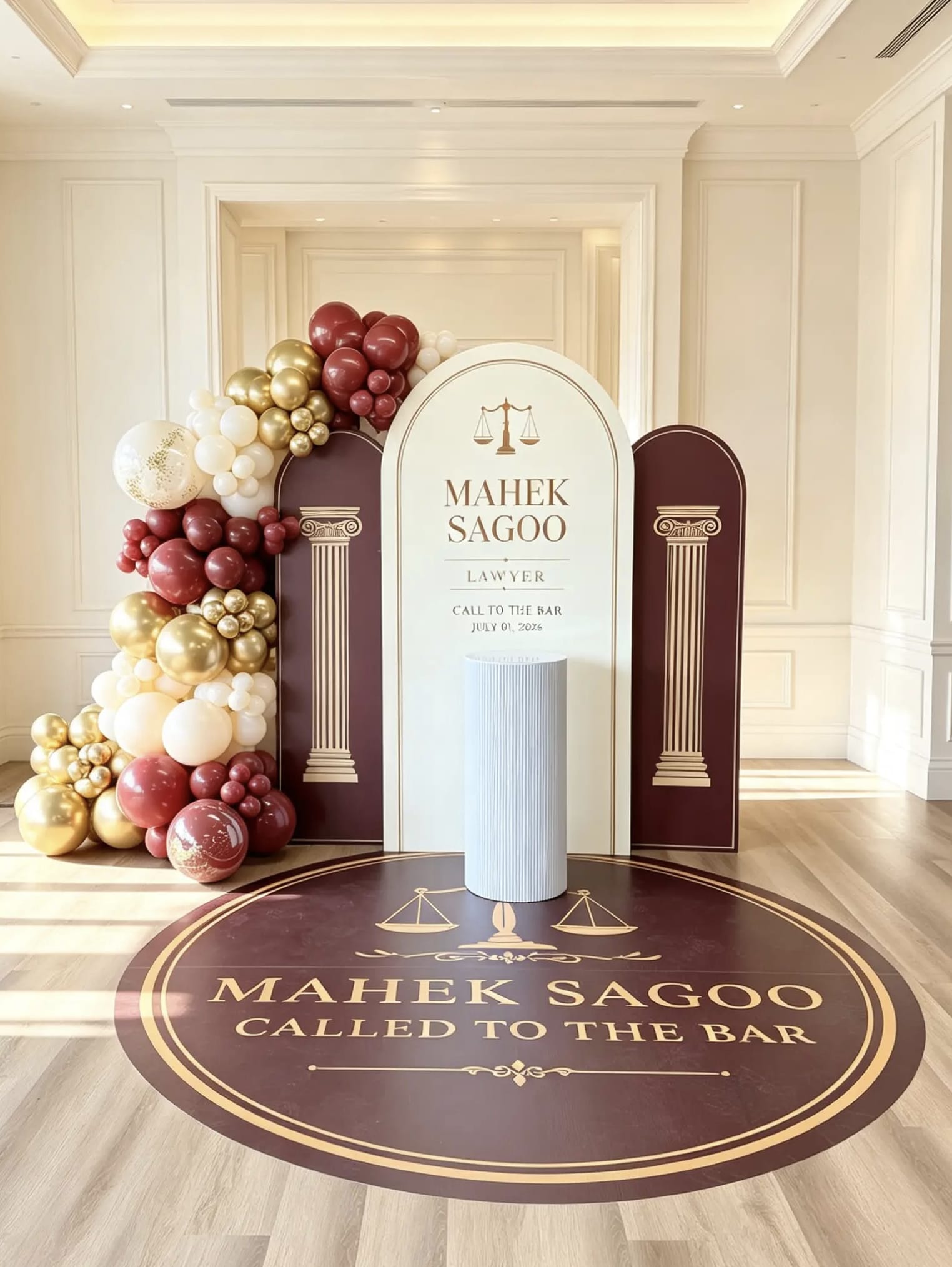 Called to the Bar celebration backdrop with burgundy, ivory and gold balloons, personalized law-themed panels, floor graphic and cake table.