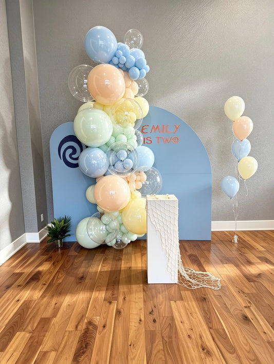 pastel moana birthday backdrop with pastel balloon garland and bubble balloons