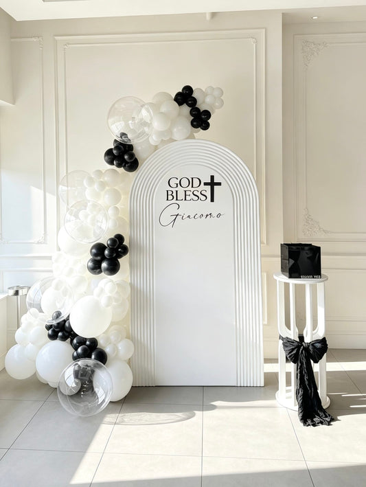 White ripple arch communion backdrop with black and white balloon garland, clear bubble balloons and pedestal stand